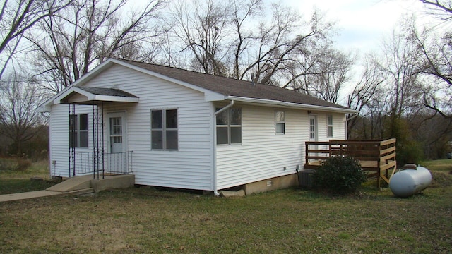 view of front of house with a front lawn and cooling unit