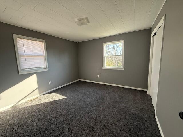 empty room with dark carpet