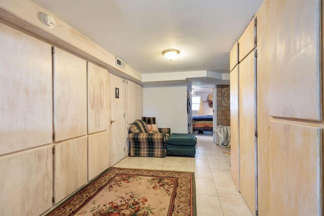 corridor featuring light tile patterned flooring