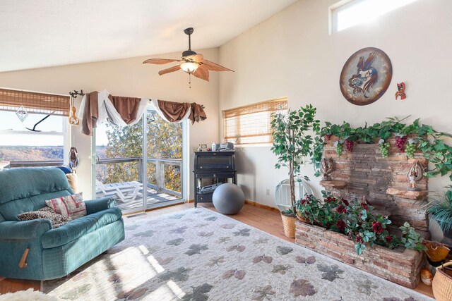 sitting room featuring hardwood / wood-style floors, ceiling fan, and high vaulted ceiling