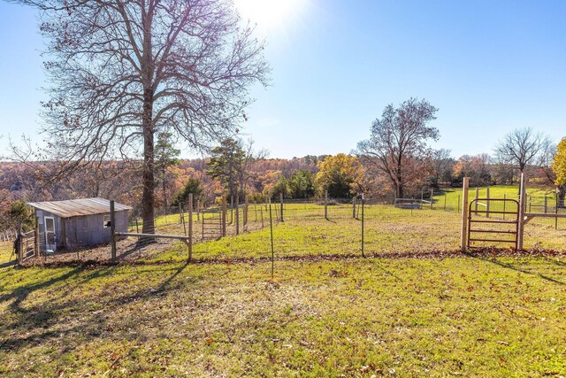 view of yard featuring an outbuilding and a rural view