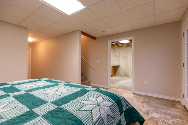 bedroom with a drop ceiling and ensuite bath