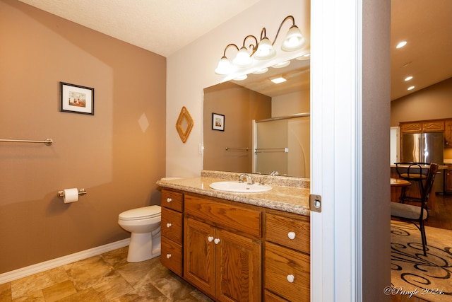 bathroom with a shower with door, vanity, vaulted ceiling, and toilet