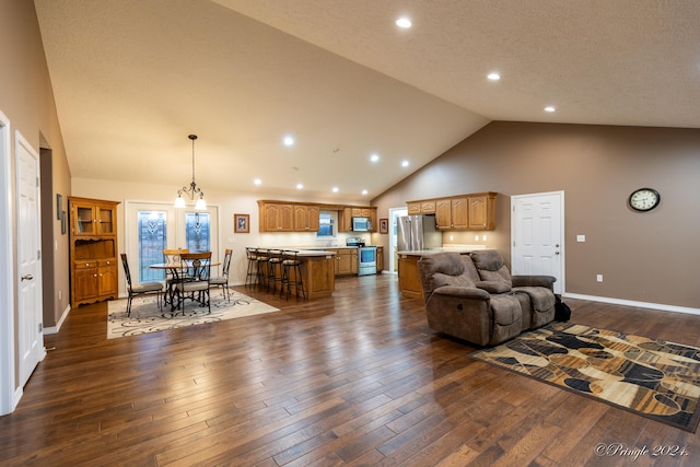 living room with a notable chandelier, dark hardwood / wood-style floors, a textured ceiling, and high vaulted ceiling