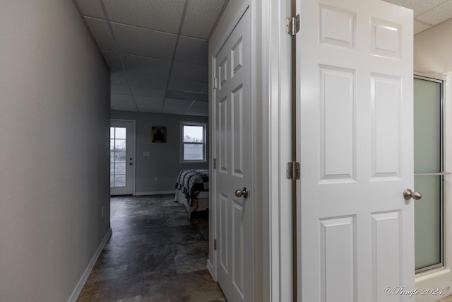 hallway featuring a paneled ceiling