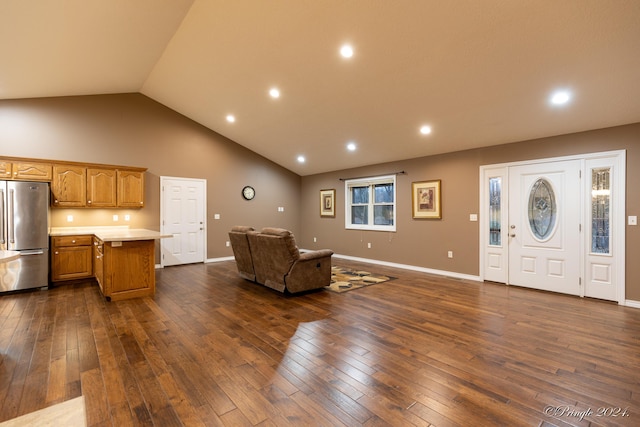 unfurnished living room featuring dark hardwood / wood-style floors and high vaulted ceiling