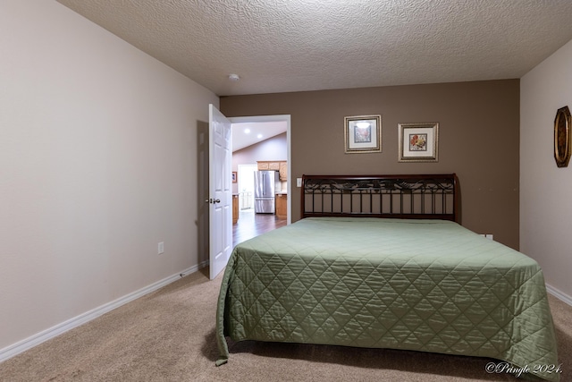 bedroom featuring stainless steel refrigerator, lofted ceiling, carpet, and a textured ceiling