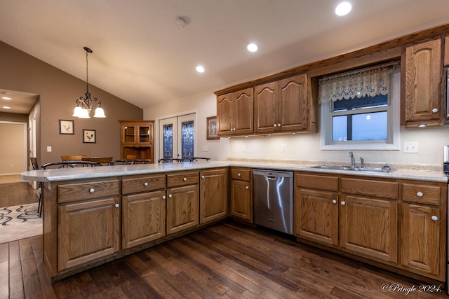 kitchen featuring kitchen peninsula, dark hardwood / wood-style flooring, vaulted ceiling, sink, and dishwasher