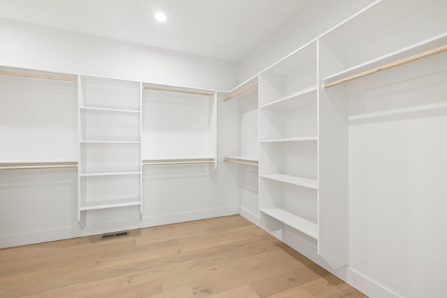 walk in closet with light wood-type flooring