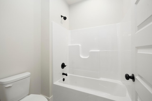 bathroom with shower / bathing tub combination and toilet