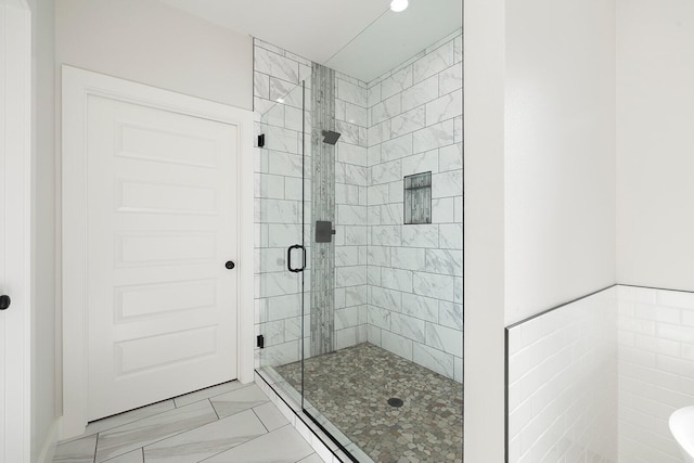 bathroom with a shower with door