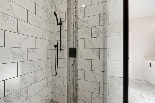 bathroom with tiled shower