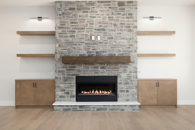 interior details featuring a fireplace and hardwood / wood-style flooring