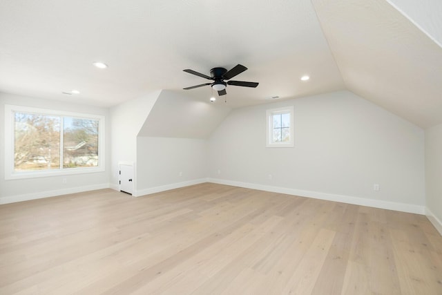 bonus room with ceiling fan, light hardwood / wood-style floors, and vaulted ceiling