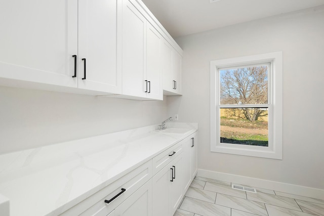 clothes washing area featuring sink