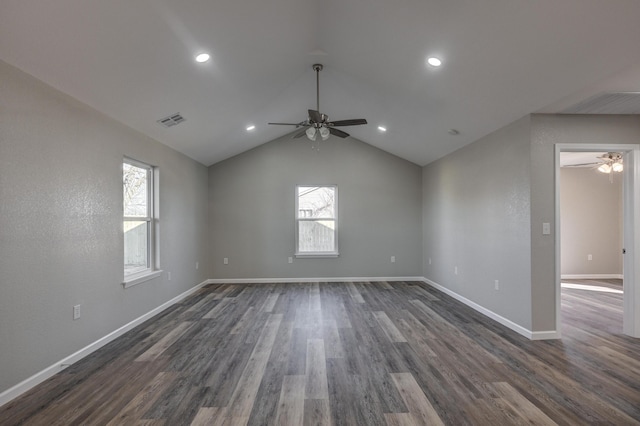 empty room featuring vaulted ceiling, ceiling fan, and dark hardwood / wood-style flooring