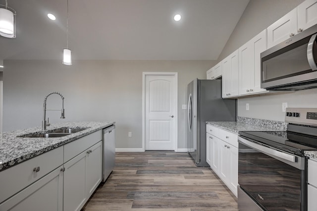 kitchen with decorative light fixtures, appliances with stainless steel finishes, sink, and white cabinetry