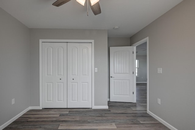 unfurnished bedroom featuring ceiling fan, a closet, and dark hardwood / wood-style floors