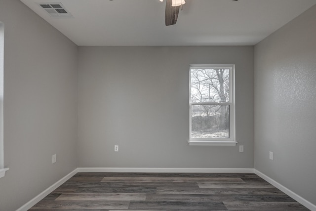 spare room with dark wood-type flooring and ceiling fan