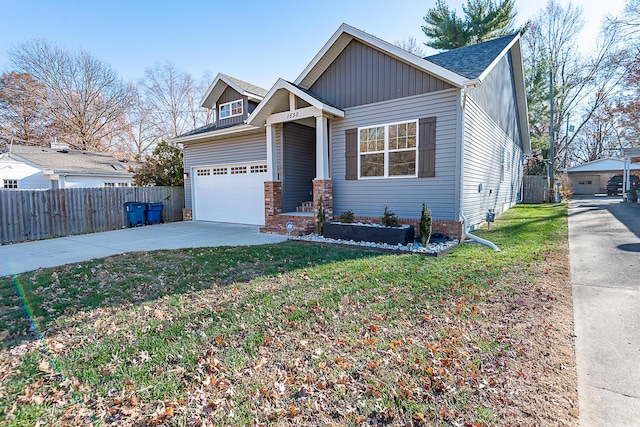 view of front of home with a garage and a front lawn