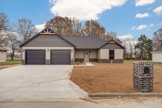 view of front of property with a garage, stone siding, roof with shingles, and concrete driveway