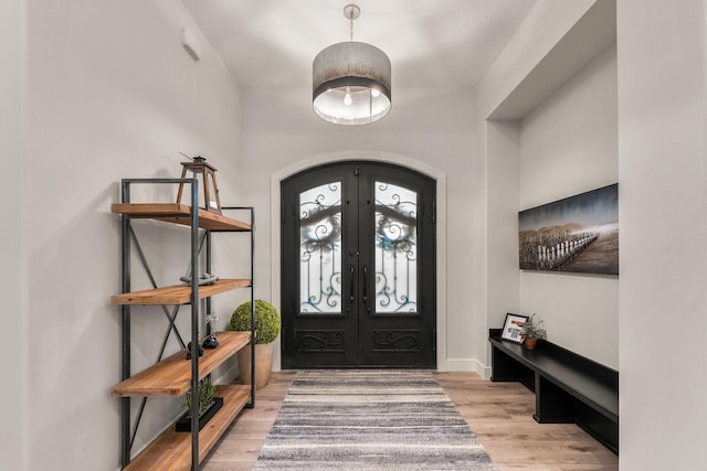 entrance foyer featuring french doors and light hardwood / wood-style floors