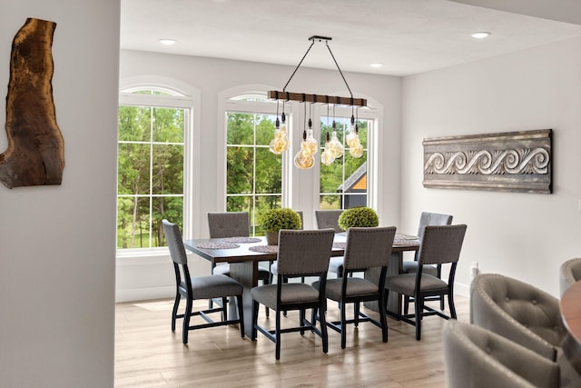 dining area with an inviting chandelier and light wood-type flooring