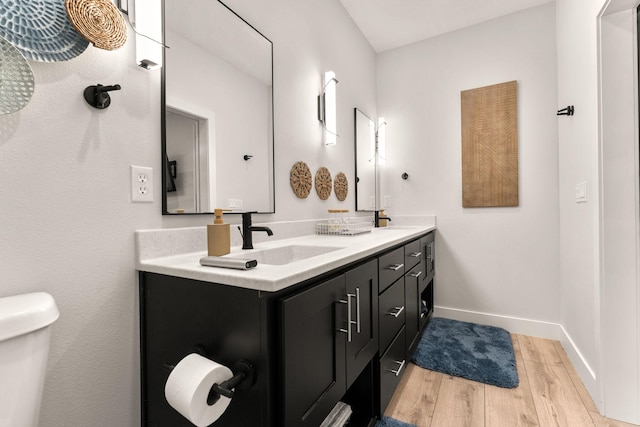 bathroom featuring hardwood / wood-style floors, vanity, and toilet