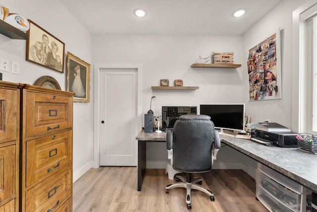 office area featuring light wood-type flooring and built in desk