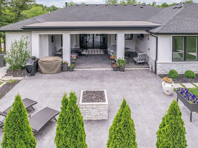 rear view of property featuring central air condition unit and a patio