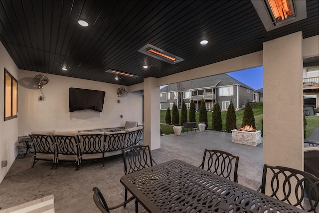 view of patio featuring an outdoor living space with a fire pit