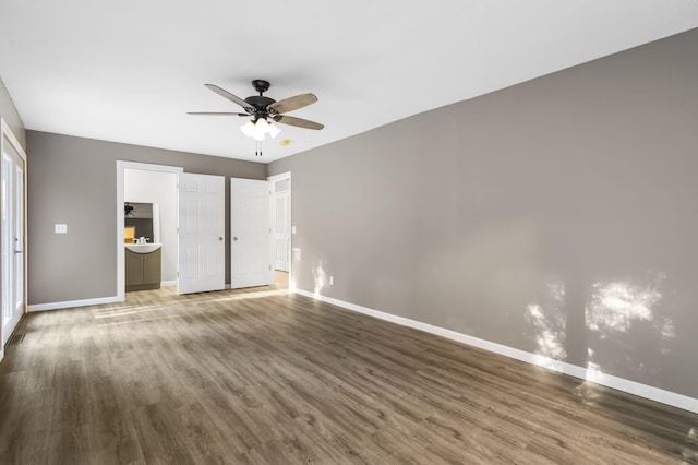 unfurnished bedroom with a ceiling fan, baseboards, and wood finished floors