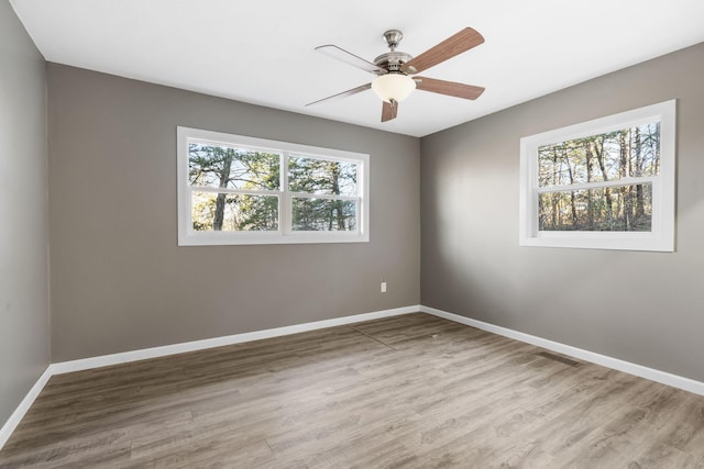 unfurnished room featuring hardwood / wood-style flooring and ceiling fan