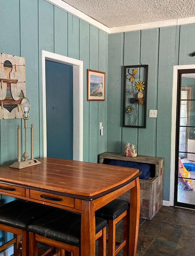 dining space with wood walls