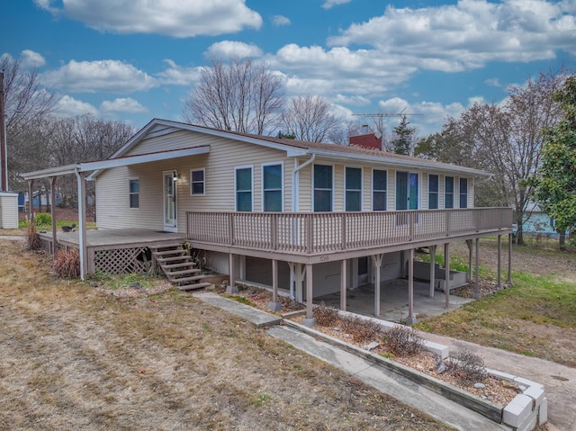 view of front of house featuring a patio area and a wooden deck