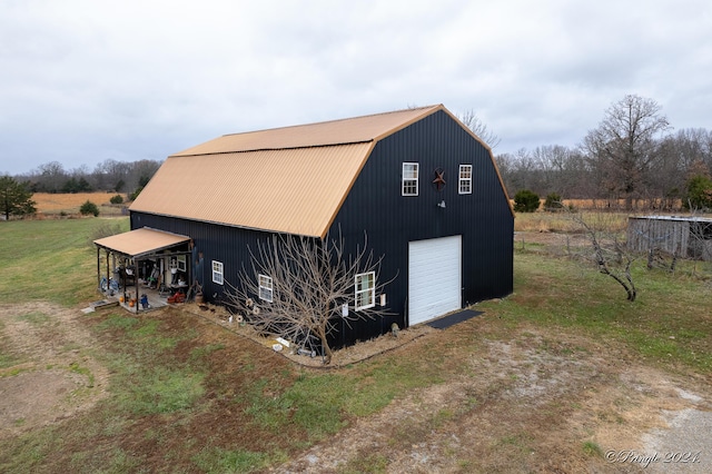 view of outbuilding with a yard and a garage