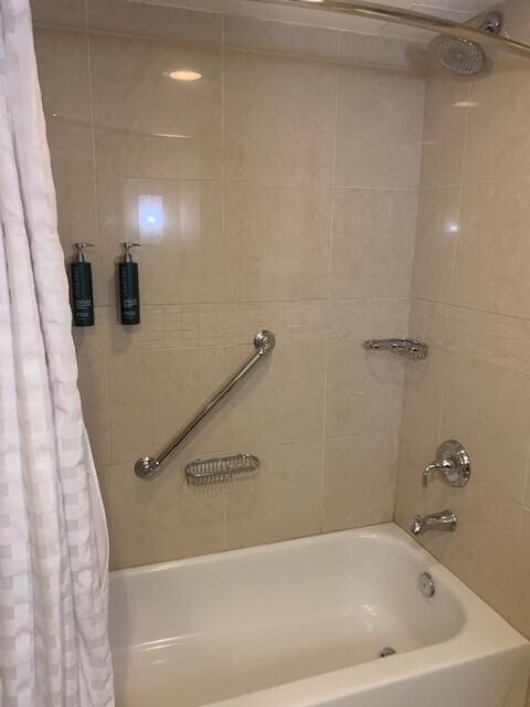 bathroom with shower / bathtub combination with curtain