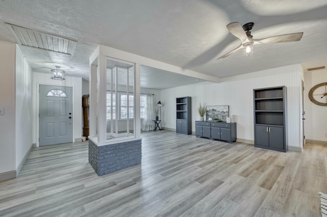 foyer featuring a textured ceiling, light hardwood / wood-style floors, and ceiling fan