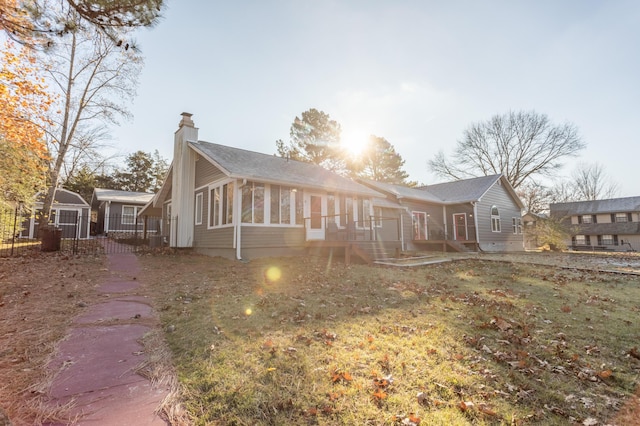 exterior space featuring a yard and a sunroom