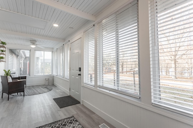 interior space with beam ceiling, ceiling fan, and wood ceiling