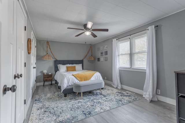 bedroom with ceiling fan and light hardwood / wood-style flooring