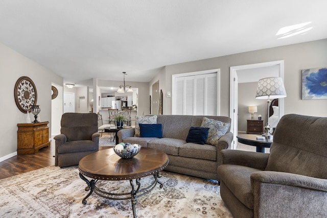 living room with a chandelier and wood-type flooring