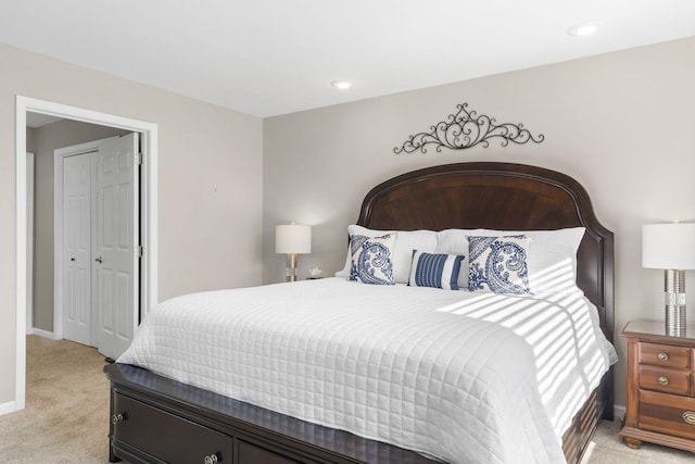 bedroom featuring light carpet and a closet