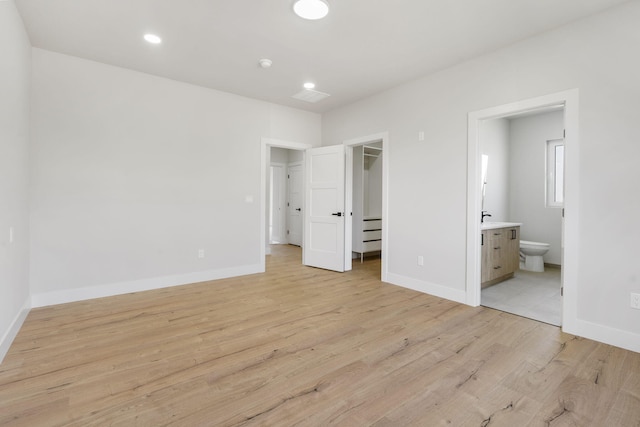 252 Hickory Hills Blvd, Springfield, MO 65802 - unfurnished bedroom with a spacious closet, light wood finished floors, and baseboards