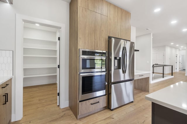 252 Hickory Hills Blvd, Springfield, MO 65802 - kitchen with light wood finished floors, stainless steel appliances, light brown cabinetry, recessed lighting, and modern cabinets