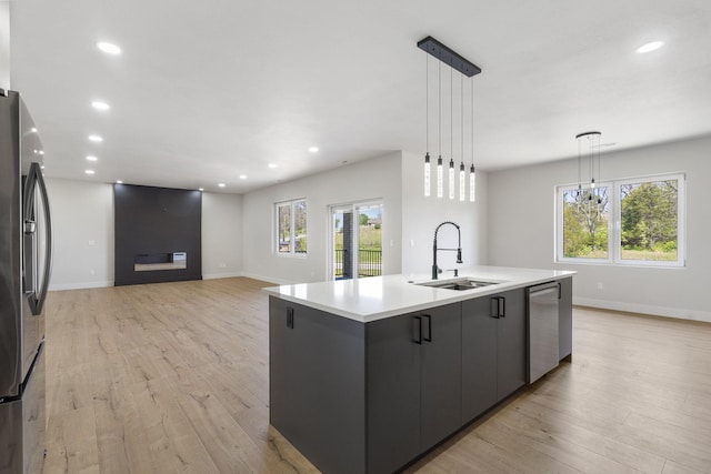 252 Hickory Hills Blvd, Springfield, MO 65802 - kitchen with stainless steel appliances, a sink, plenty of natural light, and a center island with sink