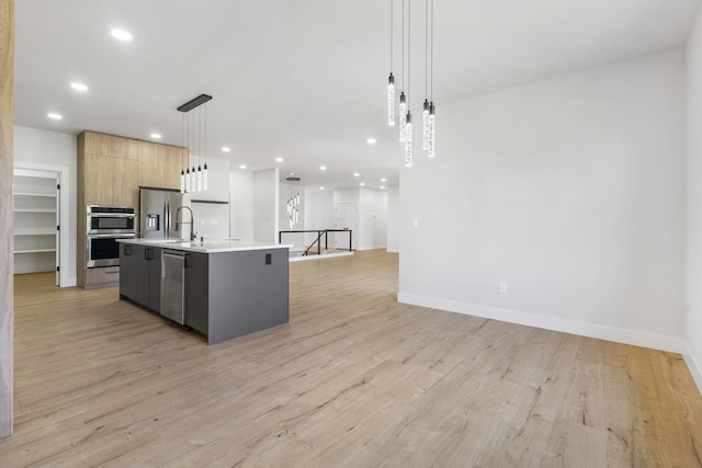 252 Hickory Hills Blvd, Springfield, MO 65802 - kitchen featuring a kitchen island with sink, modern cabinets, light countertops, appliances with stainless steel finishes, and recessed lighting