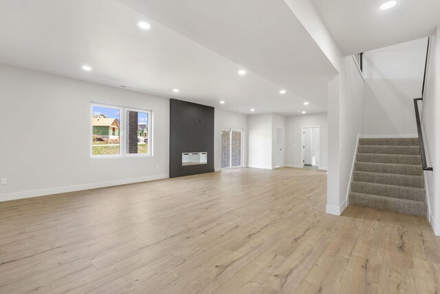 252 Hickory Hills Blvd, Springfield, MO 65802 - unfurnished living room featuring light wood-type flooring, baseboards, recessed lighting, and stairway