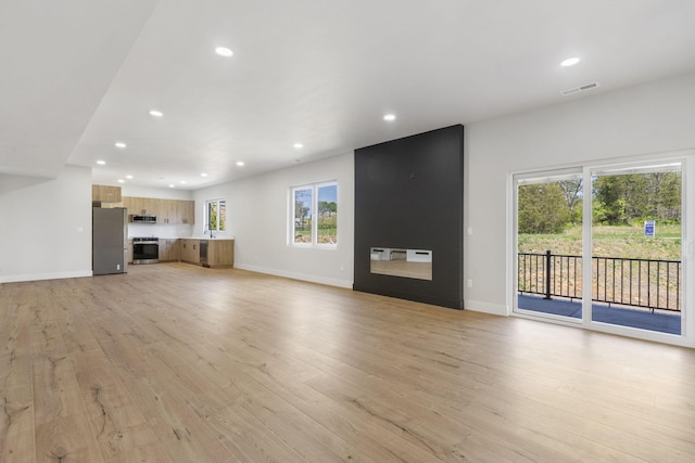 252 Hickory Hills Blvd, Springfield, MO 65802 - unfurnished living room with recessed lighting, light wood-style flooring, visible vents, and baseboards