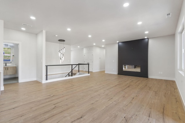 252 Hickory Hills Blvd, Springfield, MO 65802 - unfurnished living room featuring recessed lighting, visible vents, and light wood-type flooring